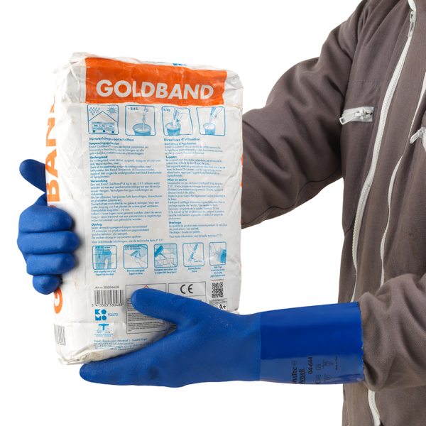 Worker handling construction material bag while wearing AlphaTec 04-644 blue chemical-resistant gloves.