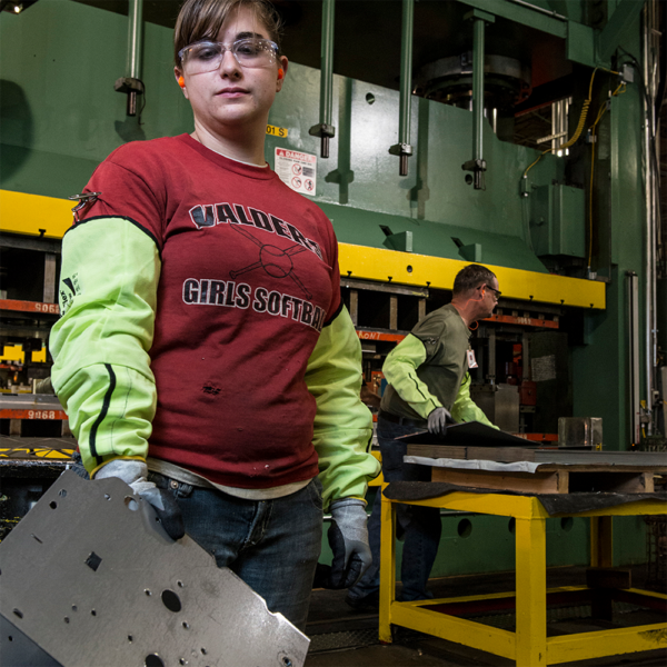Industrial worker using Ansell HyFlex 11-200 protective sleeve in metal fabrication environment