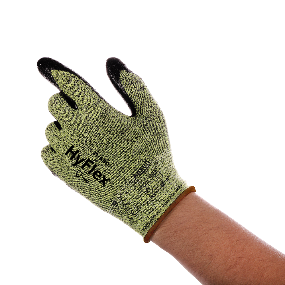 Close-up of Ansell HyFlex 11-550 glove on a hand, showing the green knit material with black dipped fingers and full branding.