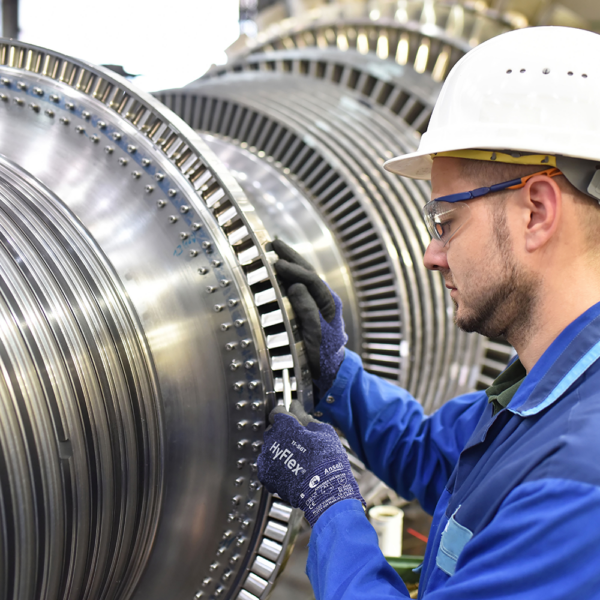 Worker wearing Ansell HyFlex 11-561 gloves inspecting industrial turbine components