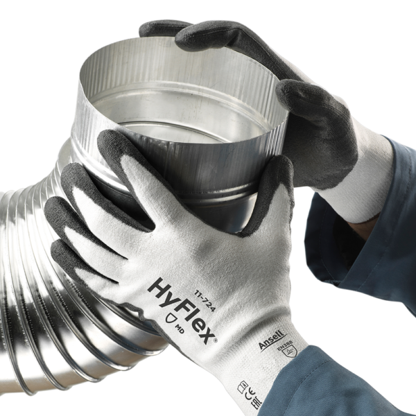 HyFlex 11-724 gloves being used to assemble metal ductwork, showcasing cut protection and dexterity.