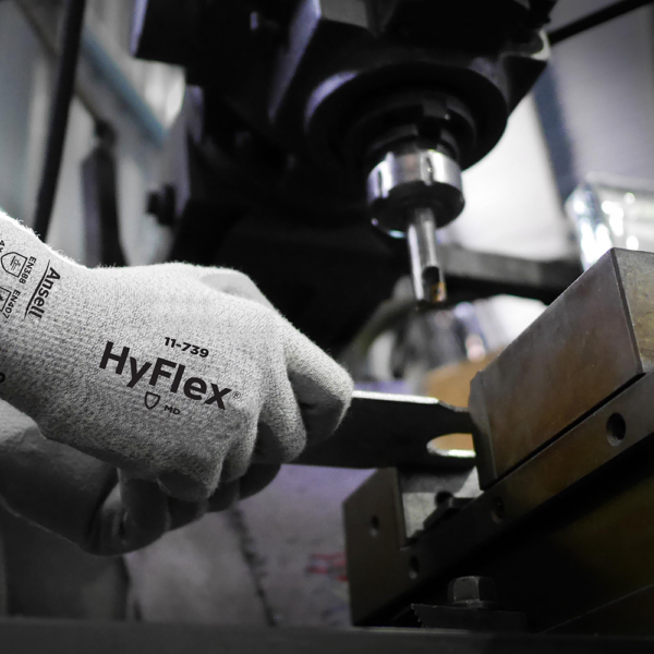 Ansell HyFlex 11-739 glove in action, gripping metal part during machinery operation