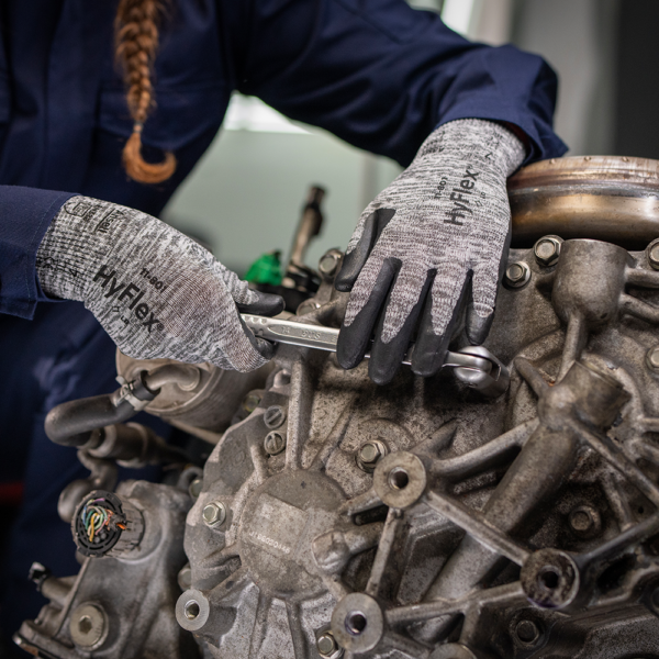 Ansell HyFlex 11-801 gloves in use during mechanical maintenance, demonstrating dexterity and grip while working on machinery.
