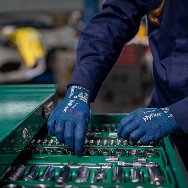 Technician wearing Ansell HyFlex 11-819 ESD gloves while accessing tools in a green drawer