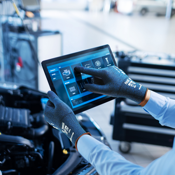 Ansell HyFlex 11-819 ESD gloves demonstrating touchscreen compatibility on a digital tablet in a workshop