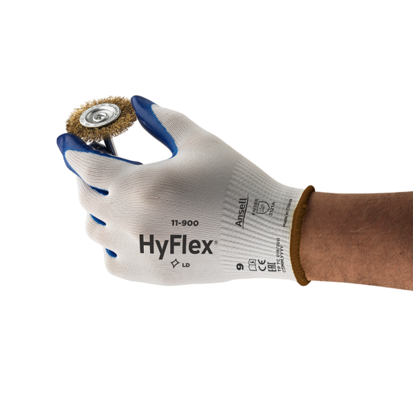 Ansell HyFlex 11-900 glove in use, gripping a wire brush wheel for mechanical handling.