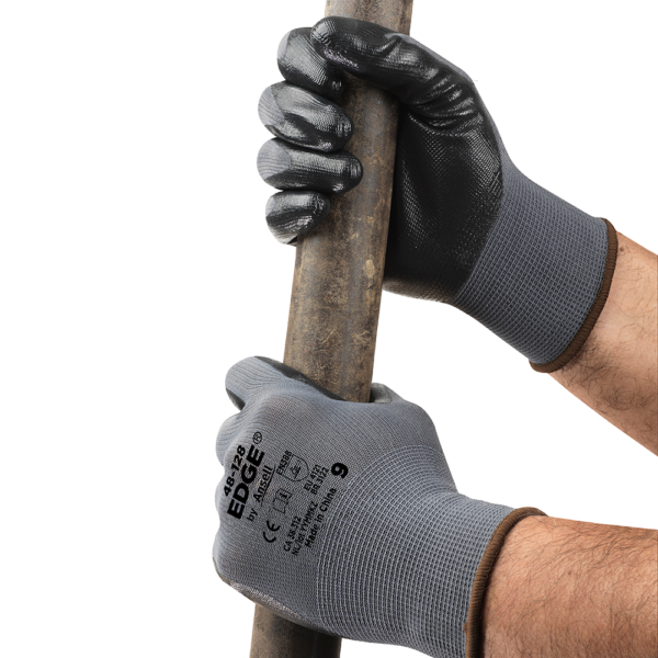 Ansell EDGE 48-128 gloves gripping a pipe, showcasing secure grip and fit during use