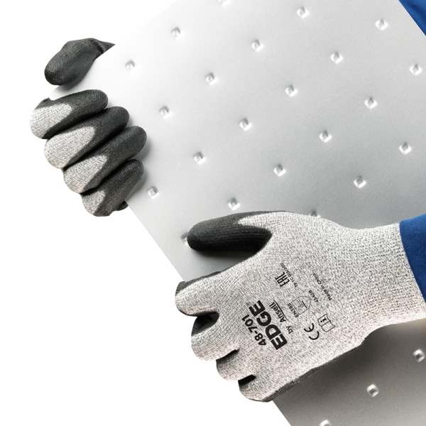 Ansell EDGE 48-701 gloves in use, gripping textured sheet metal for a secure hold