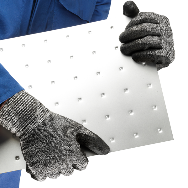 Ansell EDGE 48-705 gloves in use handling a perforated metal sheet for safe grip.