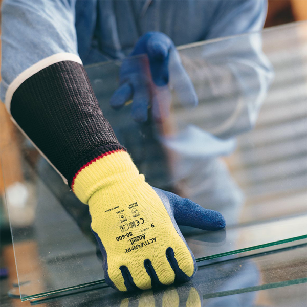Worker using Ansell ActivArmr 80-600 glove to grip and move glass panel