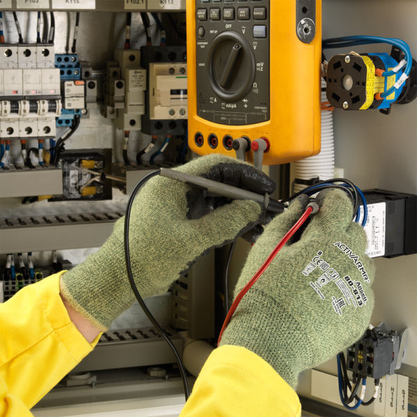 Electrician using Ansell ActivArmr 80-813 gloves while testing electrical panel with multimeter