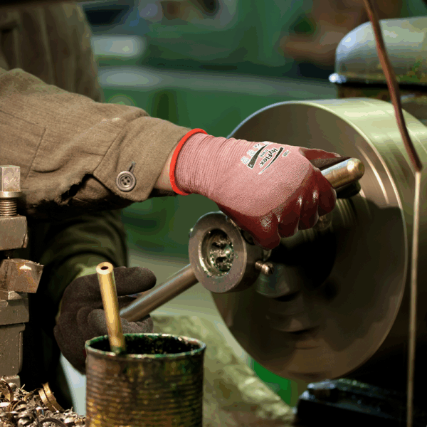 Person wearing Ansell HyFlex 11-926 gloves operating metal lathe machine